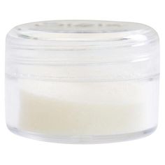 a small jar filled with white powder on a white background