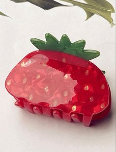 a strawberry shaped object sitting on top of a table