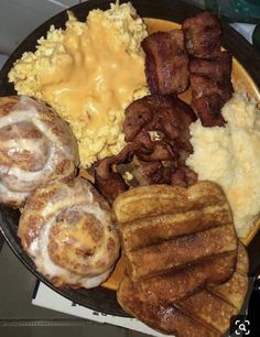 a plate full of breakfast foods including eggs, sausages and hashbrowns