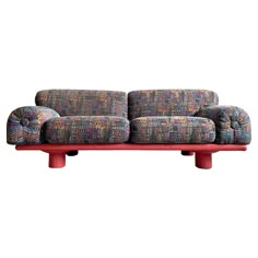 a colorful couch sitting on top of a wooden table