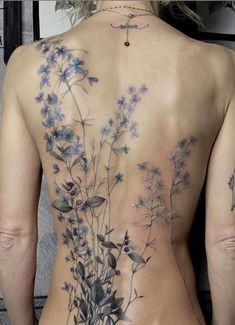 the back of a woman's body with flowers on it