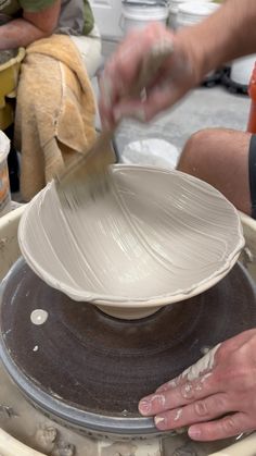 a person is making a bowl on a potter's wheel