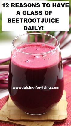 a glass filled with juice sitting on top of a table