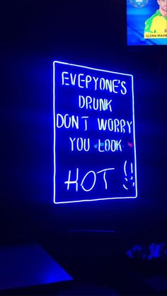 a neon sign that says everyone's drunk don't worry you look hot