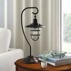 a lamp on a table next to a window