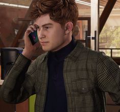 a young man is talking on his cell phone