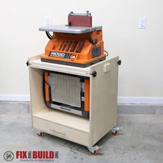 an orange and black machine sitting on top of a table