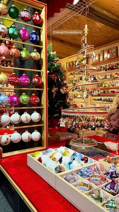 there are many ornaments on display in the store and one person is looking at them