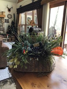 a living room filled with furniture and a large basket on top of a wooden table