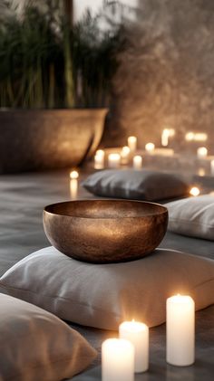 A stylish, photorealistic image of a sound therapy bowl on plush cushions surrounded by softly glowing candles. Use airy space, natural stone colors, and elegant beige-brown tones. No text! Mantra, Moon