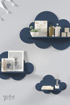 there are two shelves on the wall with clouds above them, one shelf is holding items