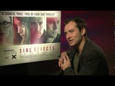 a man standing in front of a movie poster