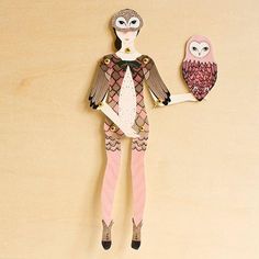 a paper doll with an owl on her arm