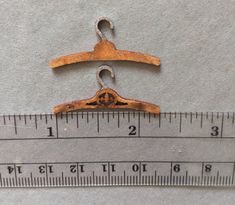 an old wooden hanger on a ruler