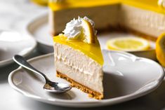 a slice of lemon cheesecake on a plate with a fork and spoon next to it