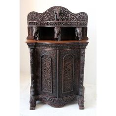 an ornate wooden cabinet with carvings on it