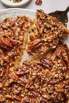 pecan pie on a plate with one slice cut out