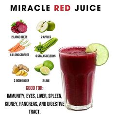 a glass filled with fruit and vegetables next to a poster that says, miracle red juice