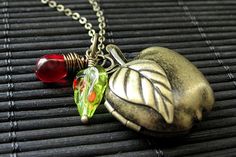 Apple Locket Necklace in Bronze with Wire Wrapped Charm and Green Leaf. A bronze apple locket dangles from a matching bronze chain in this "Apple for Teacher" necklace complete with glass red teardrop wire wrapped in bronze and green leaf charm. Necklace comes with a matching bronze chain. (If you would like a length of chain different than offered, please contact me for pricing.) There are also matching earrings! http://etsy.me/10fF7Wj If you would like to order a larger quantity than what's of Teacher Necklace, Treble Clef Necklace, Apple Necklace, Teachers Necklace, Teardrop Jewelry, Necklace Locket, Red Charm, Feminine Jewelry, Cobalt Blue Earrings