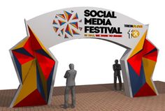 two people are standing under an arch with the words social media festival on it, in front of a white background