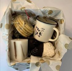 a white coffee cup filled with cookies and marshmallows