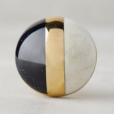 a black, white and gold object sitting on top of a table