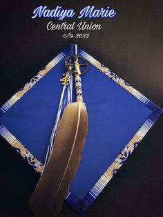 a graduation cap with a feather on it and the words madiya marie central union above it