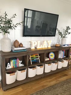 a tv mounted above a wooden shelf filled with books