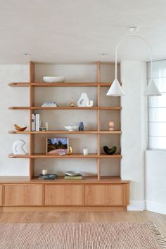 a living room filled with lots of wooden shelves