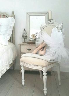 a ballerina's feet are sitting on a chair in front of a mirror