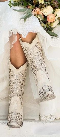 the bride's boots are decorated with flowers