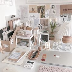 a desk with many items on it including a keyboard, mouse and other office supplies