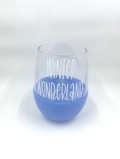 a wine glass with the words winter wonderland painted on it's side, in front of a white background