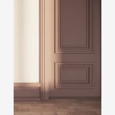 an empty room with a door and wooden floor