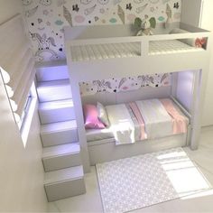 a white bunk bed sitting next to a stair case in a room with wallpaper