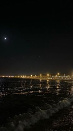 the moon shines brightly in the night sky over the ocean