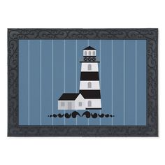 a door mat with a lighthouse on the front and blue stripes in the back ground