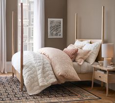 a bed with pillows and blankets in a bedroom