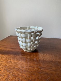 a white bowl sitting on top of a wooden table