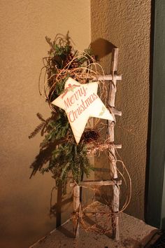 a wooden ladder with a christmas decoration on it