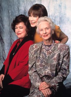 an older woman sitting next to two younger women