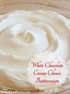 white chocolate cream cheese buttercream in a glass bowl with the words, white chocolate cream cheese buttercream