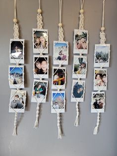 several pictures hanging on the wall with tassels attached to each photo and string