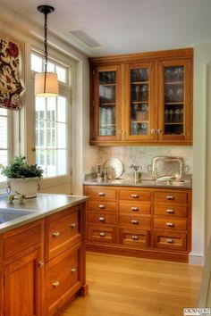 a kitchen with wooden cabinets and white counter tops