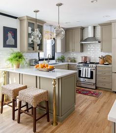 an instagramted photo of a kitchen with two stools in front of the island