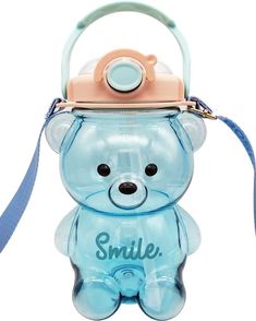 a small blue teddy bear with a pink hat on it's head and the words smile