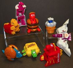 there are many mcdonald's toys on the table