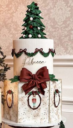 a three tiered cake decorated with christmas trees and presents on it's sides