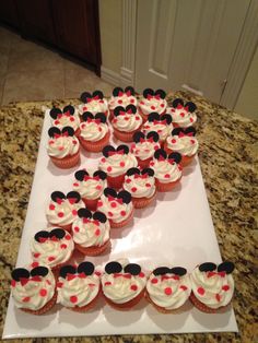 mickey mouse cupcakes are arranged on a white plate