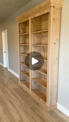 an empty room with wooden shelves and hard wood flooring